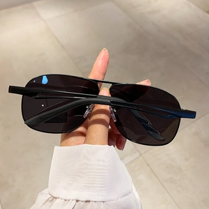 Detail of black aviator sunglasses with metal frame and polarized lenses for driving