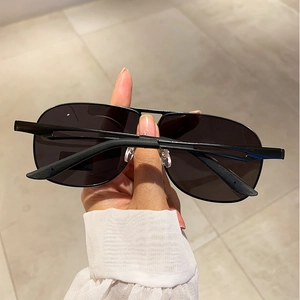 Close-up of black metal aviator polarized sunglasses with classic foldable frame