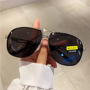 Close-up of polarized aviator sunglasses with silver metal frame and dark grey lenses