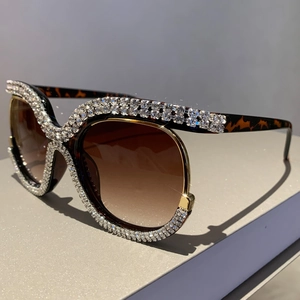 Detail of tortoise shell sunglasses frame with sparkling rhinestones and gold accents