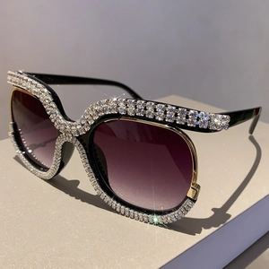 Macro view of gradient lenses and luxury rhinestone crystal accents on large sunglasses