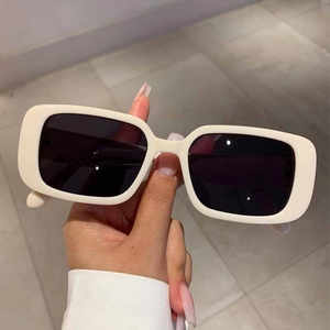 Detailed view of vintage rectangular sunglasses with thick creamy white acetate frames