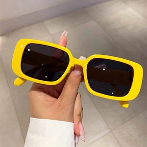 Detail shot of vintage bright yellow rectangular sunglasses with dark UV lenses