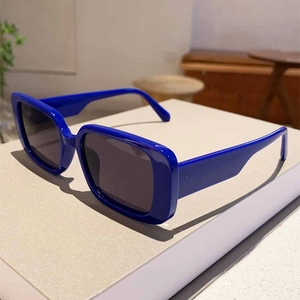Detail view of stylish blue square frame sunglasses with UV protection dark grey lenses
