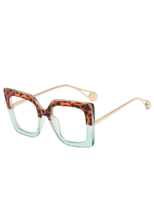 Detail of square glasses frame with tortoise pattern, green bottom and pearl temple tips