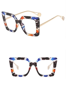 Detail view of colorful square frame glasses with golden metal temples and pearl accents