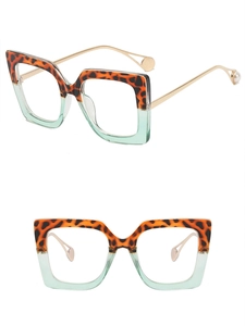 Detail of square glasses with tortoiseshell frame and mint green lower half with pearl tip