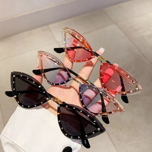 Three cat-eye sunglasses with rhinestone trim in black, gradient purple, and red shades