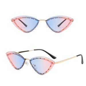 Cat eye rimless sunglasses with pink-blue gradient lenses and diamond accents