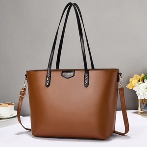 Brown leather tote bag with long handles and adjustable strap for office and commute