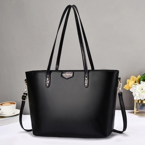 Black large capacity tote bag with adjustable shoulder strap and matte finish