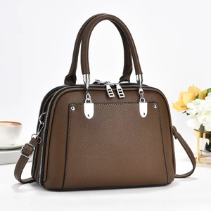 Brown lychee texture leather tote bag with triple zipper pockets and detachable shoulder strap