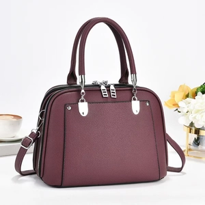 Deep burgundy pebbled leather tote bag with silver hardware and adjustable shoulder strap