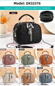 Close-up of quilted PU leather handbag with metal chain and bear charm detail
