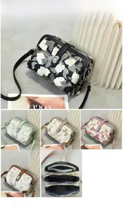 Detailed view of floral embroidery handbag with dimensions 21x8x15cm and five color options