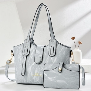 Light gray crinkle-textured tote bag set with golden logo and detachable shoulder strap