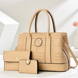 Close-up of beige three-piece bag set with textured leather and gold metal details
