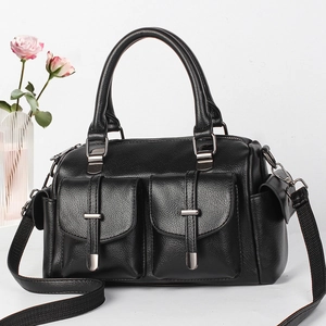 Detail of black litchi grain leather handbag with dual front buckle pockets and silver hardware