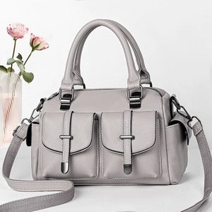 Light grey pebble leather boston bag with side pockets and a wide woven shoulder strap