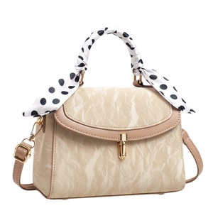 Beige marbled pattern crossbody bag with golden clasp and polka dot scarf handle