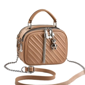 Stylish khaki quilted square crossbody bag with silver bear charm and tassel detail