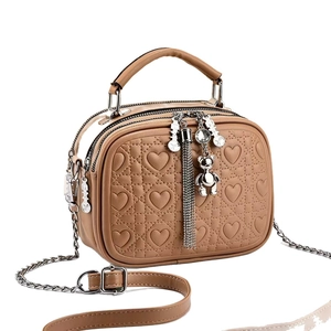 Brown heart-quilted crossbody bag with dual zippers and silver chain strap