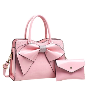 Pink bow-adorned patent leather handbag set with rhinestone accents and matching pouch