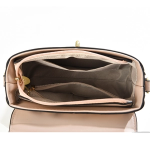 Detailed interior of a pink crossbody bag featuring gray lining and multiple compartments
