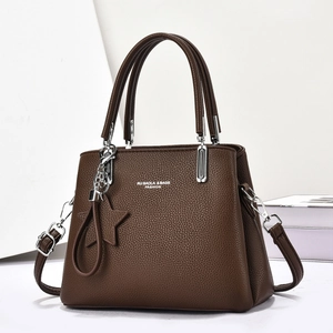 Dark brown pebble leather tote bag with top handles, star charm and adjustable strap