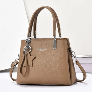 Brown litchi grain leather handbag with silver hardware and a star-shaped pendant