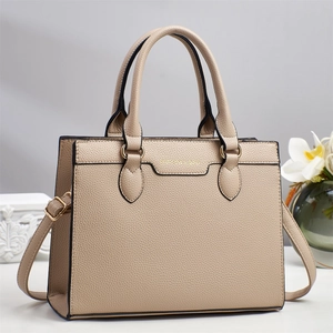 Minimalist beige leather tote bag with grainy texture and golden logo for office commute