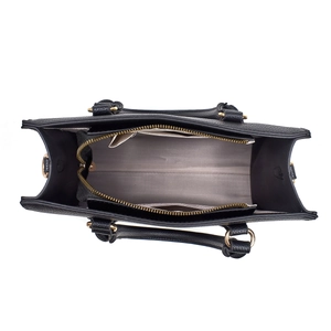 Detailed interior of black litchi leather handbag with herringbone lining and golden hardware