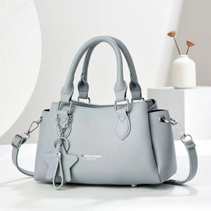 Grey litchi leather crossbody handbag with star pendant and detachable shoulder strap