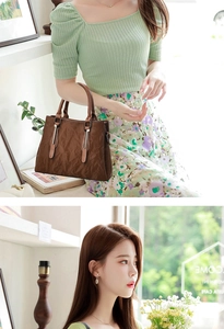 Detail of dark brown leather tote featuring pleated texture and vintage hardware