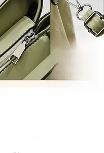 Close-up of the smooth zipper and fine edge oil craft on this green faux leather handbag