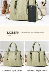 Detailed view of light green pleated shoulder bag with handle and size comparison