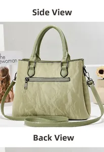 Detail view of the soft light green crossbody bag with a back zipper pocket design