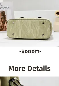 Detail view of the protective metal feet on the textured leather tote bag bottom