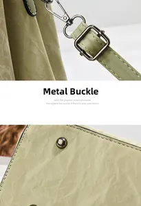 Close-up of gunmetal hardware buckle and textured leather strap on green tote bag