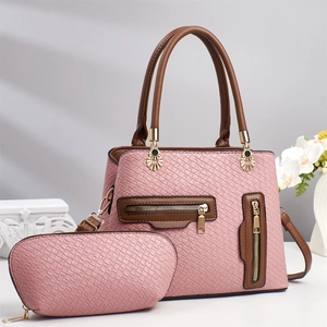 Close-up of pink woven texture handbag set with brown handles and golden hardware details