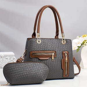 Detail of grey woven texture tote bag and matching pouch with gold hardware