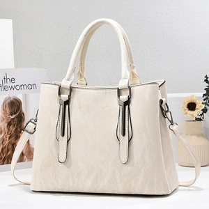 Elegant off-white textured leather tote bag with dual handles and adjustable strap
