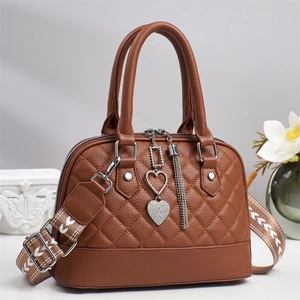 Brown quilted PU leather handbag with sparkling heart charm and tassels in warm setting