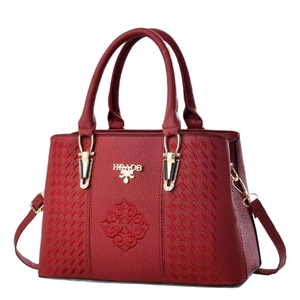 Elegant wine red leather handbag with floral embroidery and golden metal logo detailing