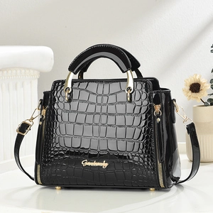 Black crocodile embossed patent leather tote bag with gold metal handles and strap