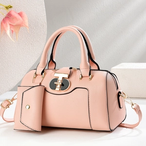 Detail of light pink Saffiano leather handbag with gold T-lock and mini pouch accessory
