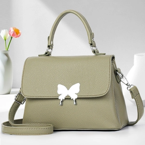 Elegante grasgrüne Handtasche aus Leder mit silbernem Schmetterlingsverschluss