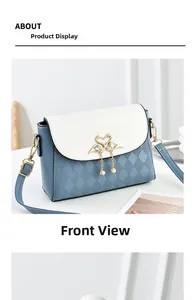 Detail of blue and white square handbag featuring gold swan buckle and pearl tassel
