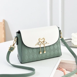 Elegant sage green and white crossbody bag with quilted texture and golden swan clasp