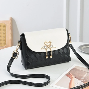 Chic black and white square crossbody bag with quilted pattern and gold bird charm